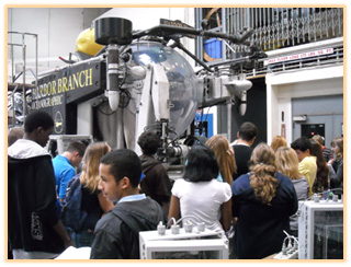 Group of students gathered around the Harbor Branch Oceanographic Institute submersible, likely on a tour or educational visit.