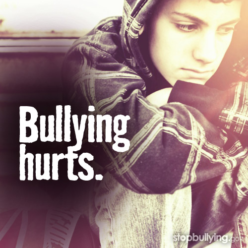 Bullying Hurts A sad-looking young boy in a hooded plaid shirt sits with his head down. The text "Bullying hurts." is superimposed on the image, with a link to stopbullying.gov.