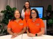 Three smiling women wearing matching shirts with "Families Matter" logo.