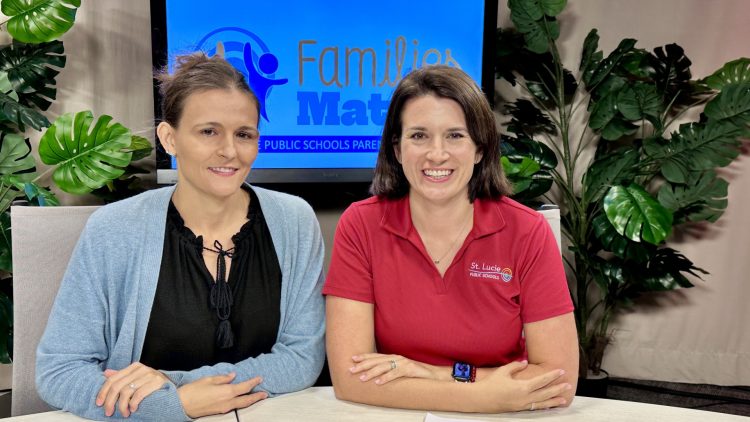 Two women from St. Lucie Public Schools smiling at a table.