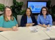 Three women from Families Matter sit at a table with mugs in a studio setting.