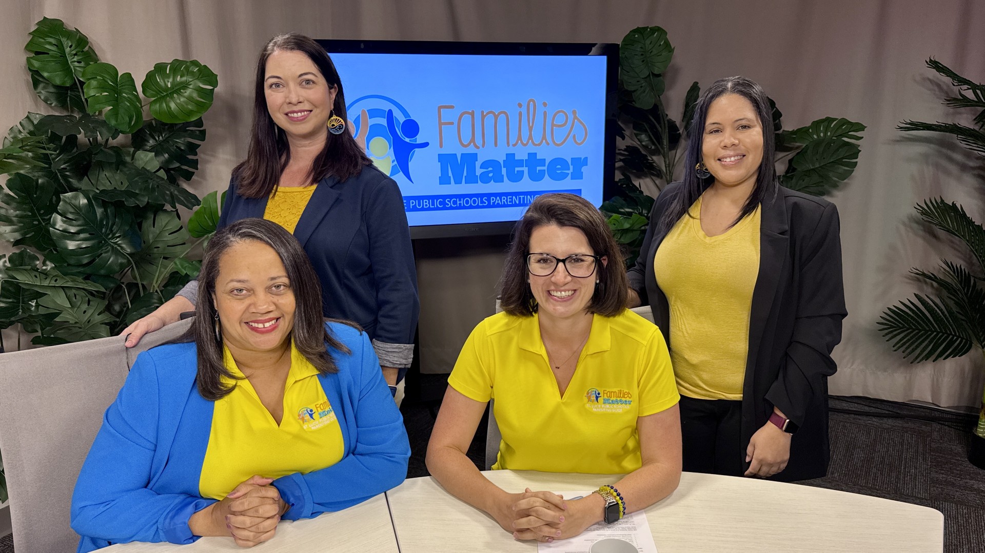 Families Matter Public Schools Parenting Four women in yellow and blue "Families Matter" shirts pose for a photo.