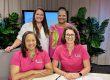 Four women promoting St. Lucie Public Schools Parenting Guide, wearing branded shirts.